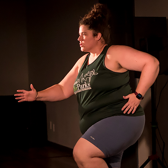 Eileen Tull on stage performing while running.